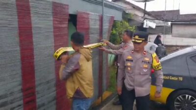 Petugas Polsek Cibadak memasang garis polisi di tempat kejadian perkara, Kampung Babakan Anyar, Kelurahan/Kecamatan Cibadak, Kabupaten Sukabumi.